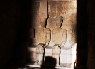 Ramesses II statue is illuminated by the Sun